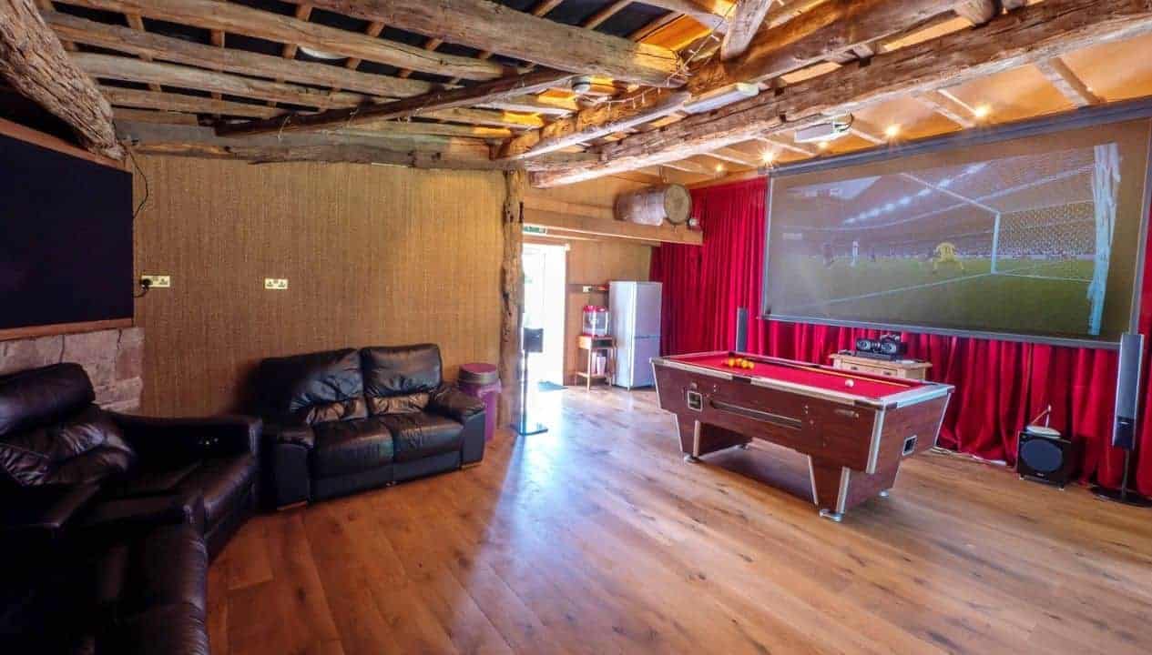 Monnow Valley Studio, Monmouthshire – Games room with black leather sofa, pool table and large projection screen.