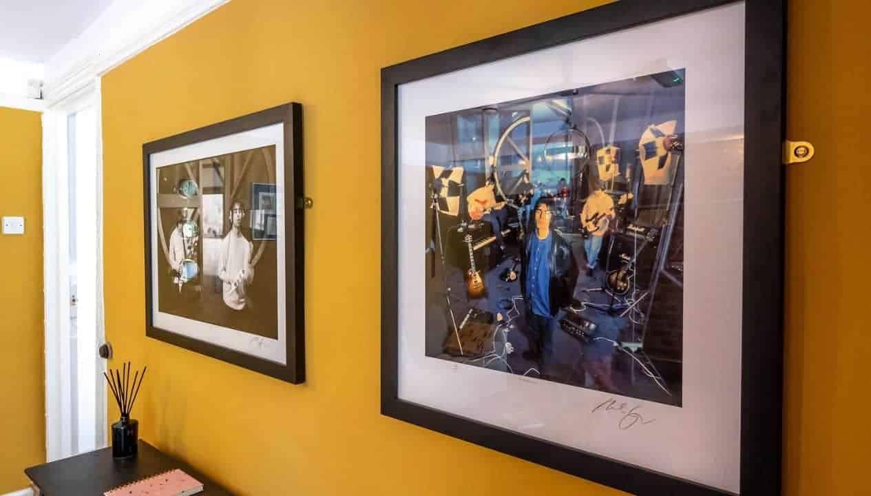 Monnow Valley Studio, Monmouthshire – Yellow wall with framed music studio photographs and decorative diffuser.