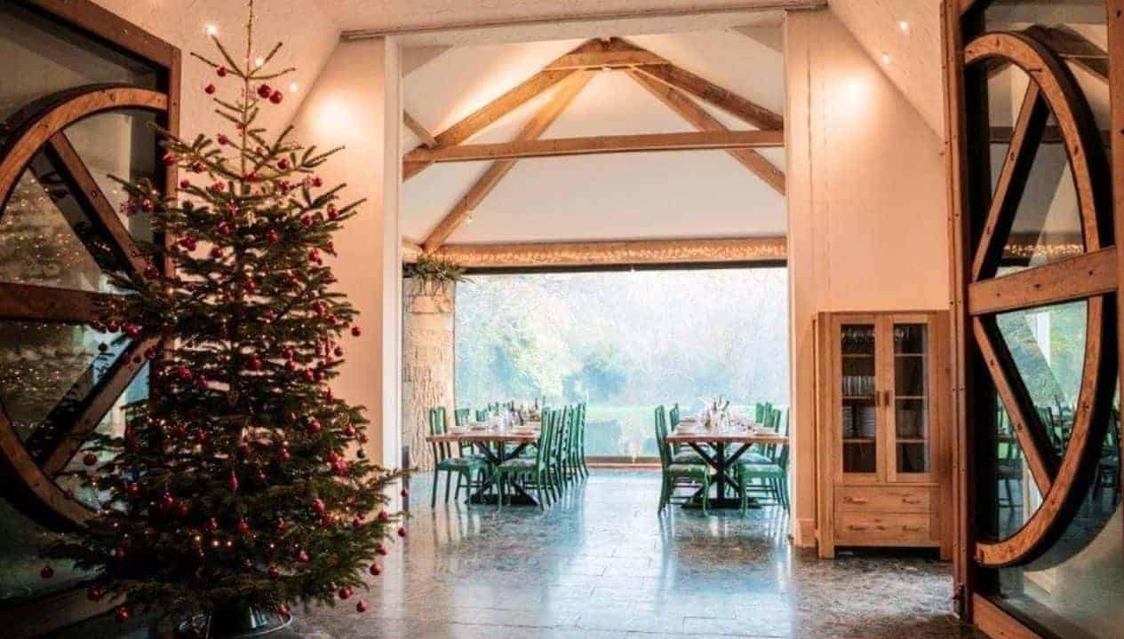 Monnow Valley Studio, Monmouthshire – Festive Christmas tree and exposed timber beams in spacious open-plan interior with valley views.