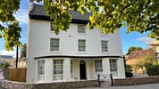 Brookside, Herefordshire – White-rendered Georgian house with slate roof and sash windows, stone boundary wall.