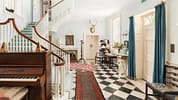 Upper Court, Gloucestershire – Grand entrance hall with curved wooden staircase, black and white tiled floor, and piano.