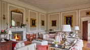 Barton Court, Herefordshire – Formal drawing room with decorative plasterwork ceiling, marble fireplace and gilt-framed portraits.