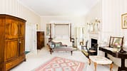 Upper Court, Gloucestershire – Spacious bedroom with four-poster bed, mahogany wardrobe and fireplace.