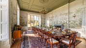 Manar House, Aberdeenshire – Formal dining room with botanical wallpaper, chandelier, and mahogany table.
