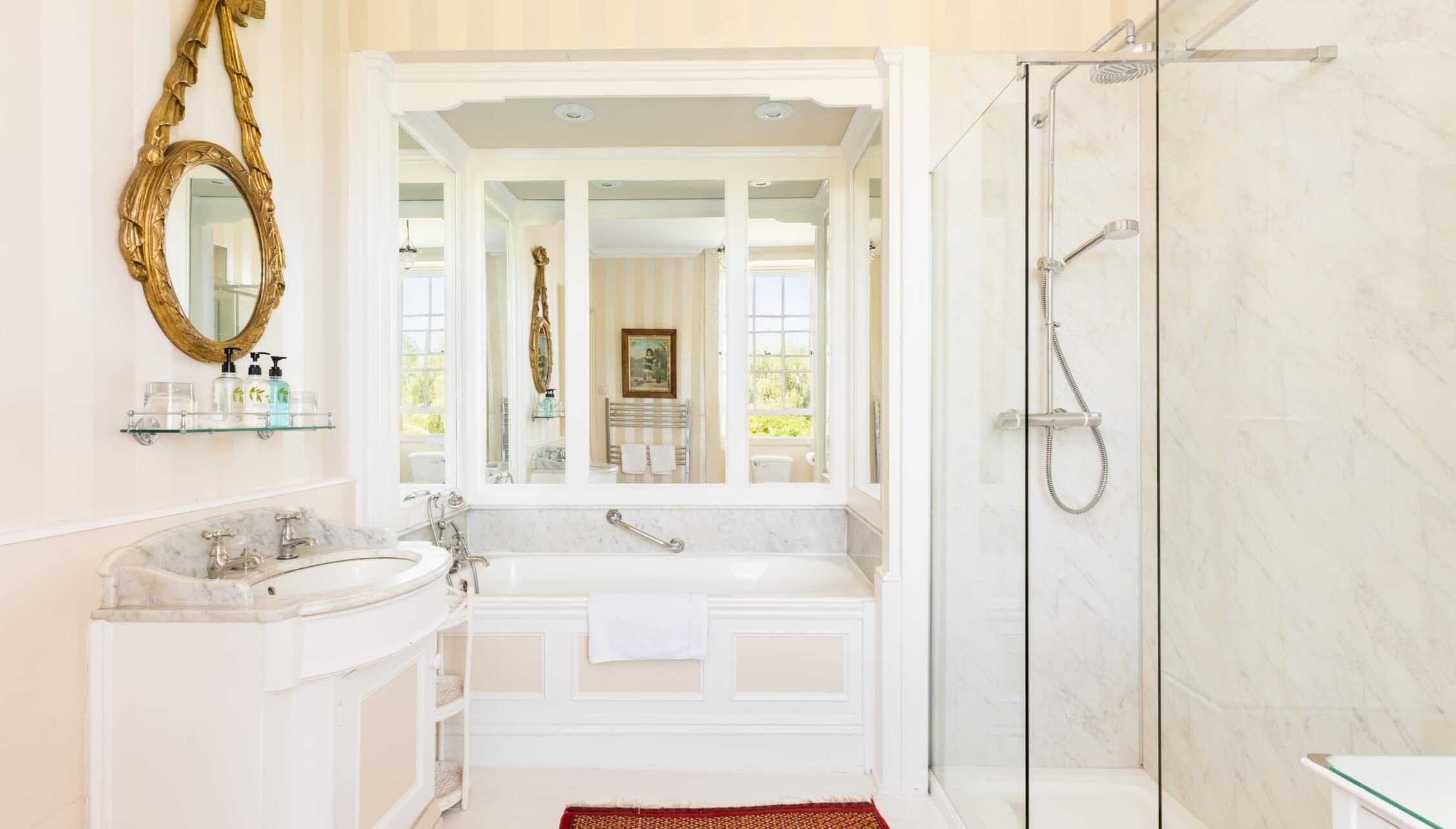 Upper Court, Gloucestershire – Ensuite bathroom with marble basin, large mirror and walk-in shower enclosure.