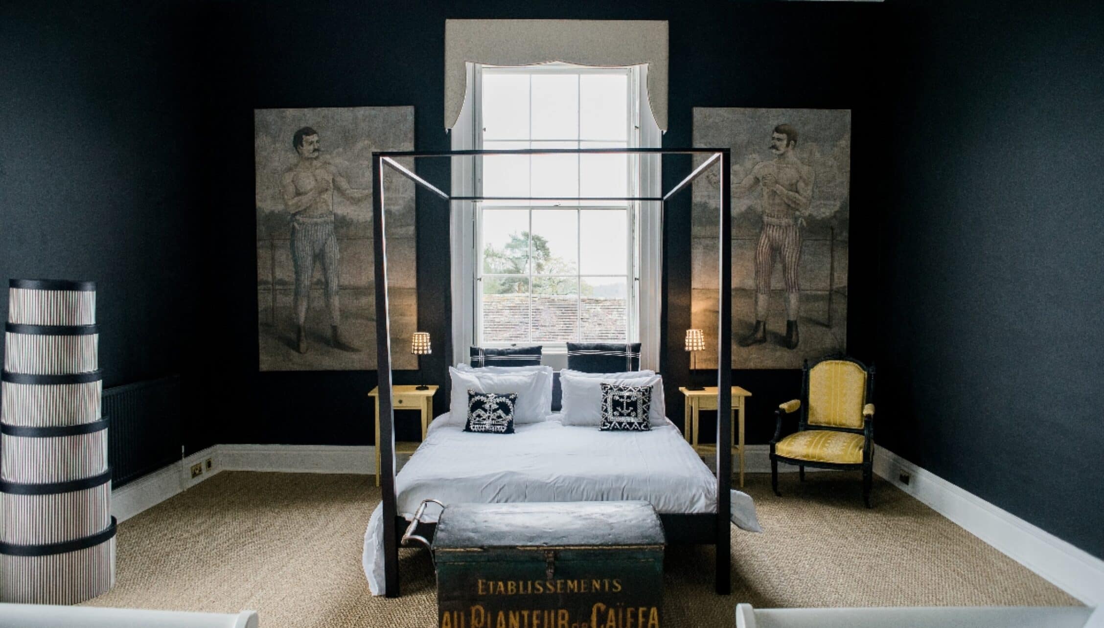 Barton Court, Herefordshire – Four-poster bed with black canopy in dark teal bedroom with classical artwork.