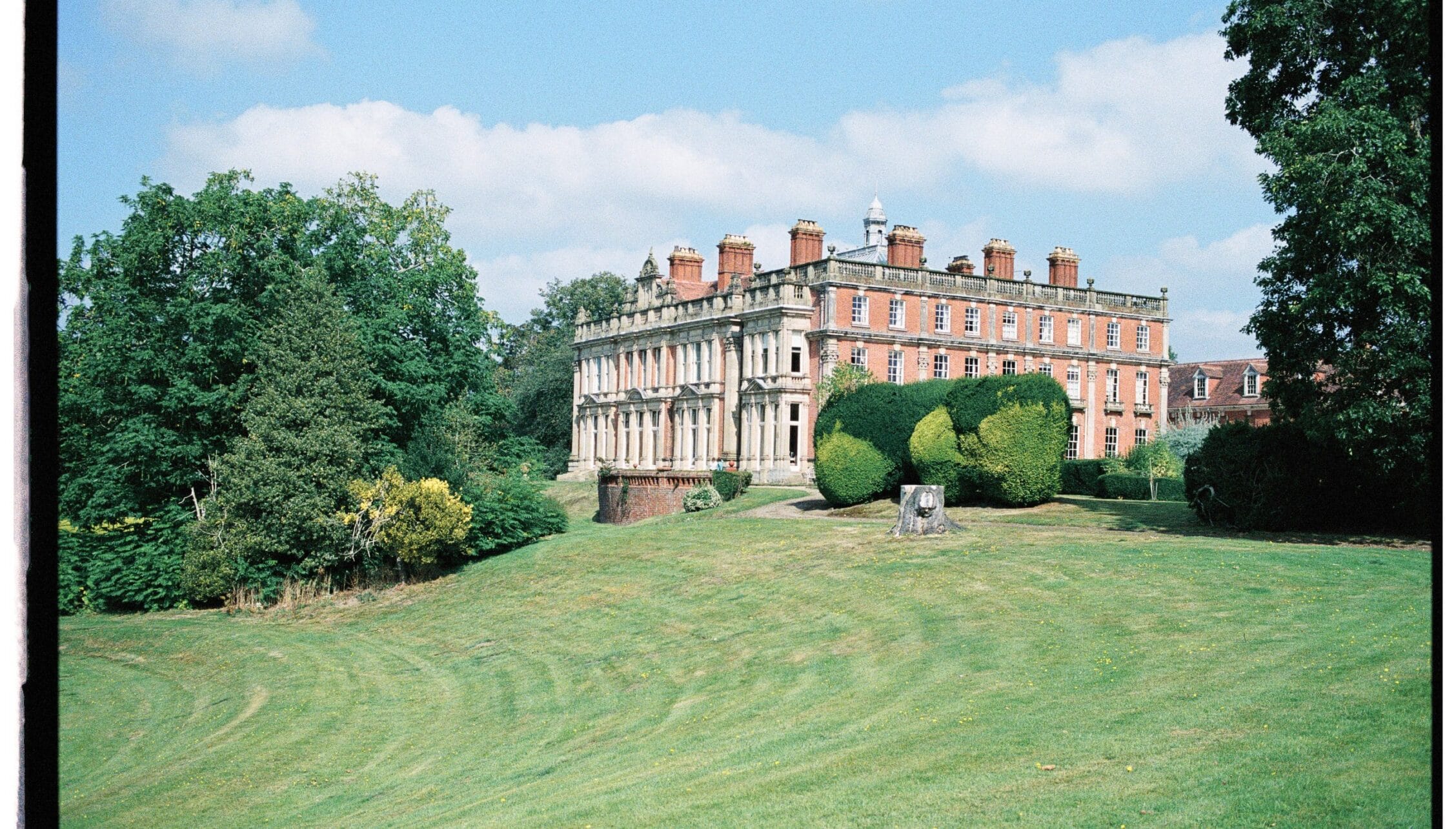 Berwick House, Shropshire – Red-brick country house with manicured lawns and specimen topiary shrubs.