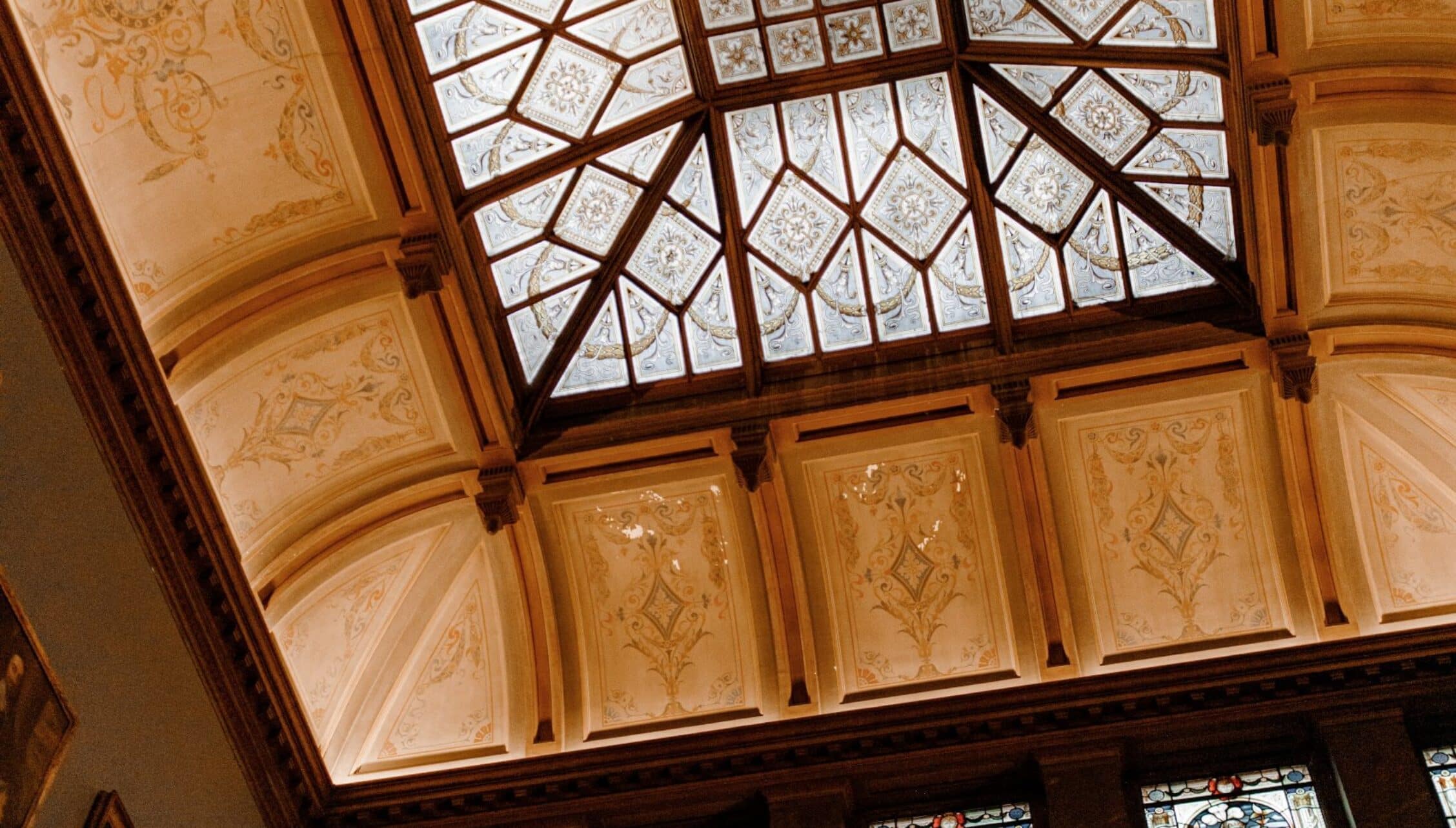 Berwick House, Shropshire – Ornate ceiling with geometric glazed skylight and decorative wall panels in warm tones.