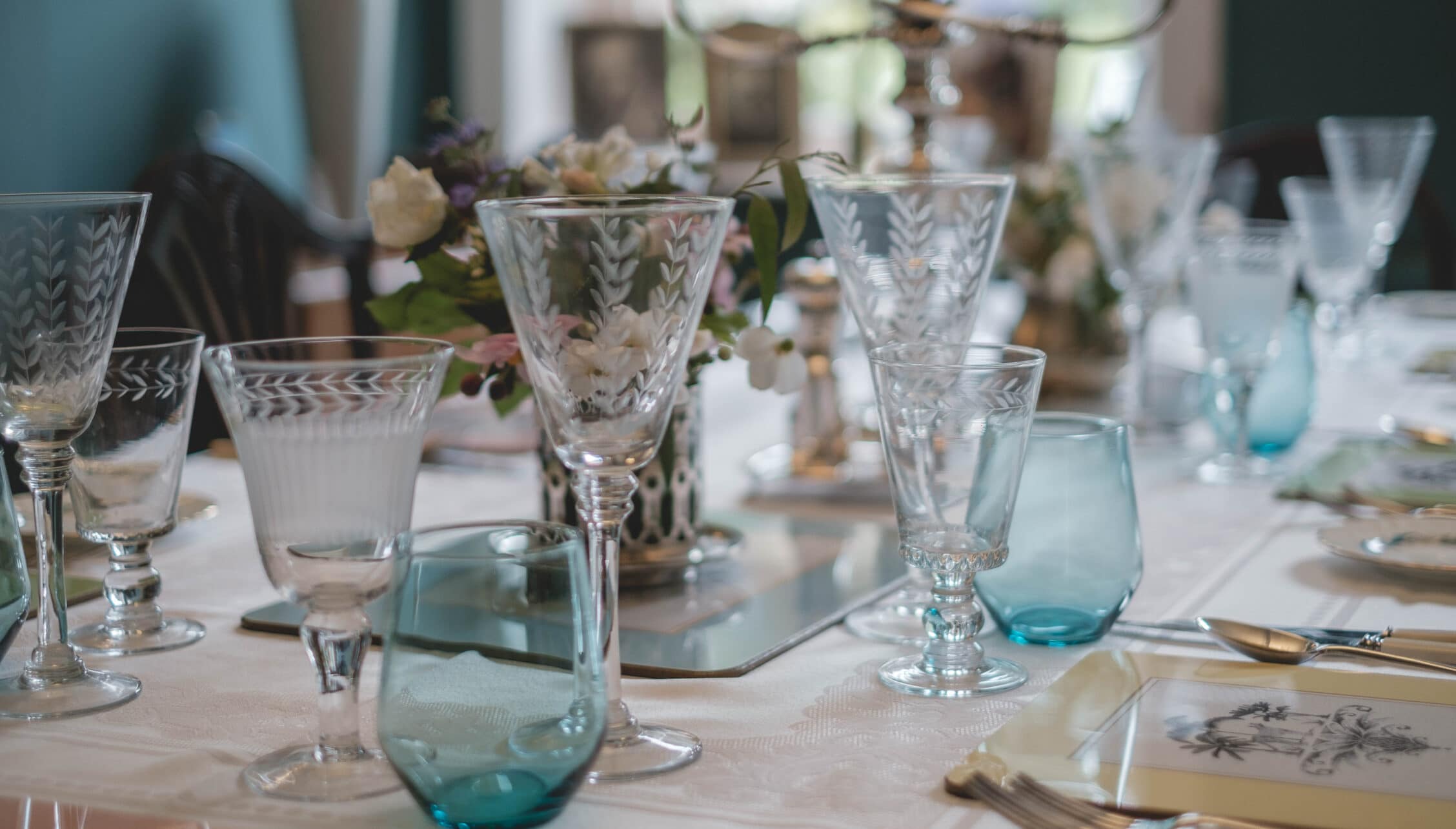 Breedon Hall, Leicestershire – Formal dining table set with cut-glass stemware and floral centrepieces.