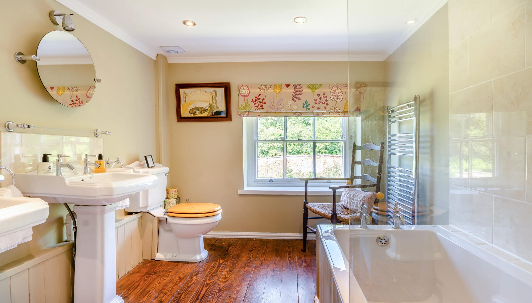 Breedon Hall, Leicestershire – Spacious bathroom with pedestal sink, wooden flooring, and walk-in shower enclosure.