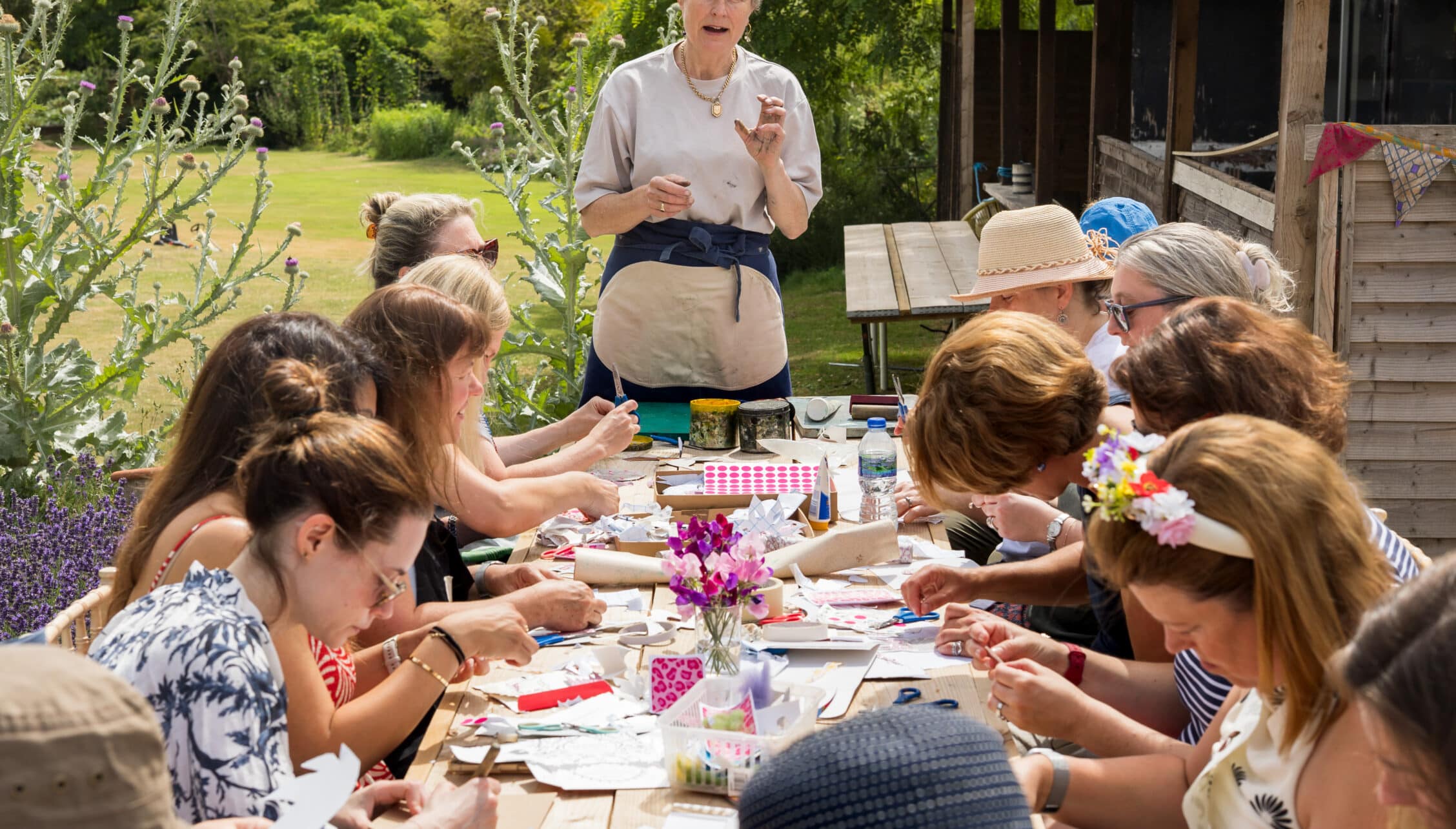 Courtyard Cottages, Gloucestershire – Outdoor craft workshop on garden terrace with lavender borders and woodland views.