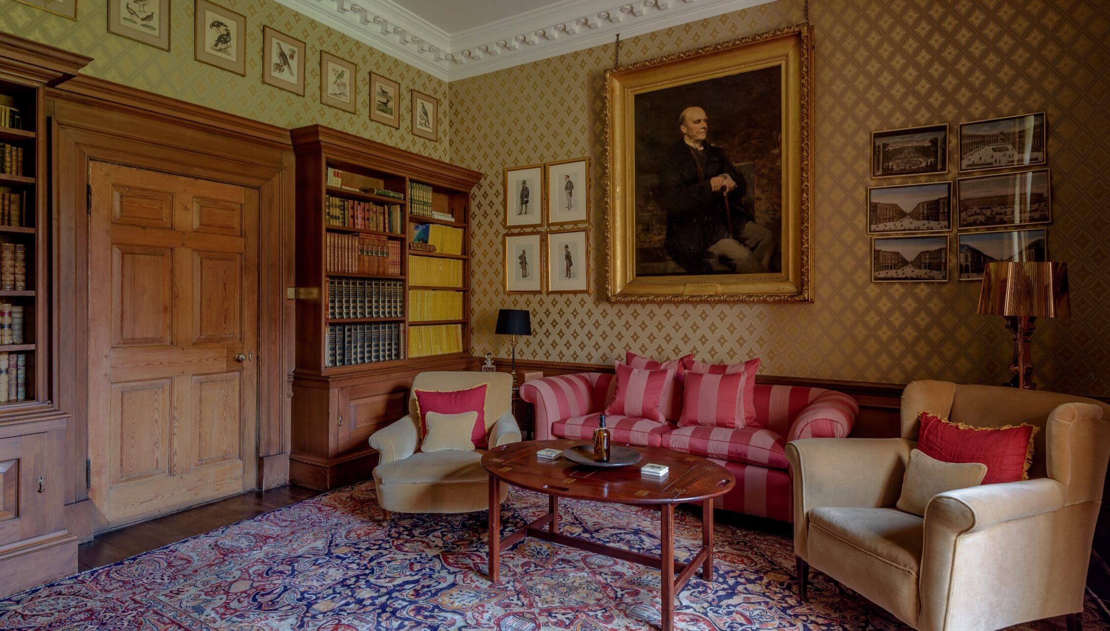 Gilmerton House, East Lothian – Drawing room with red striped sofa, cream armchairs and damask patterned wallpaper.