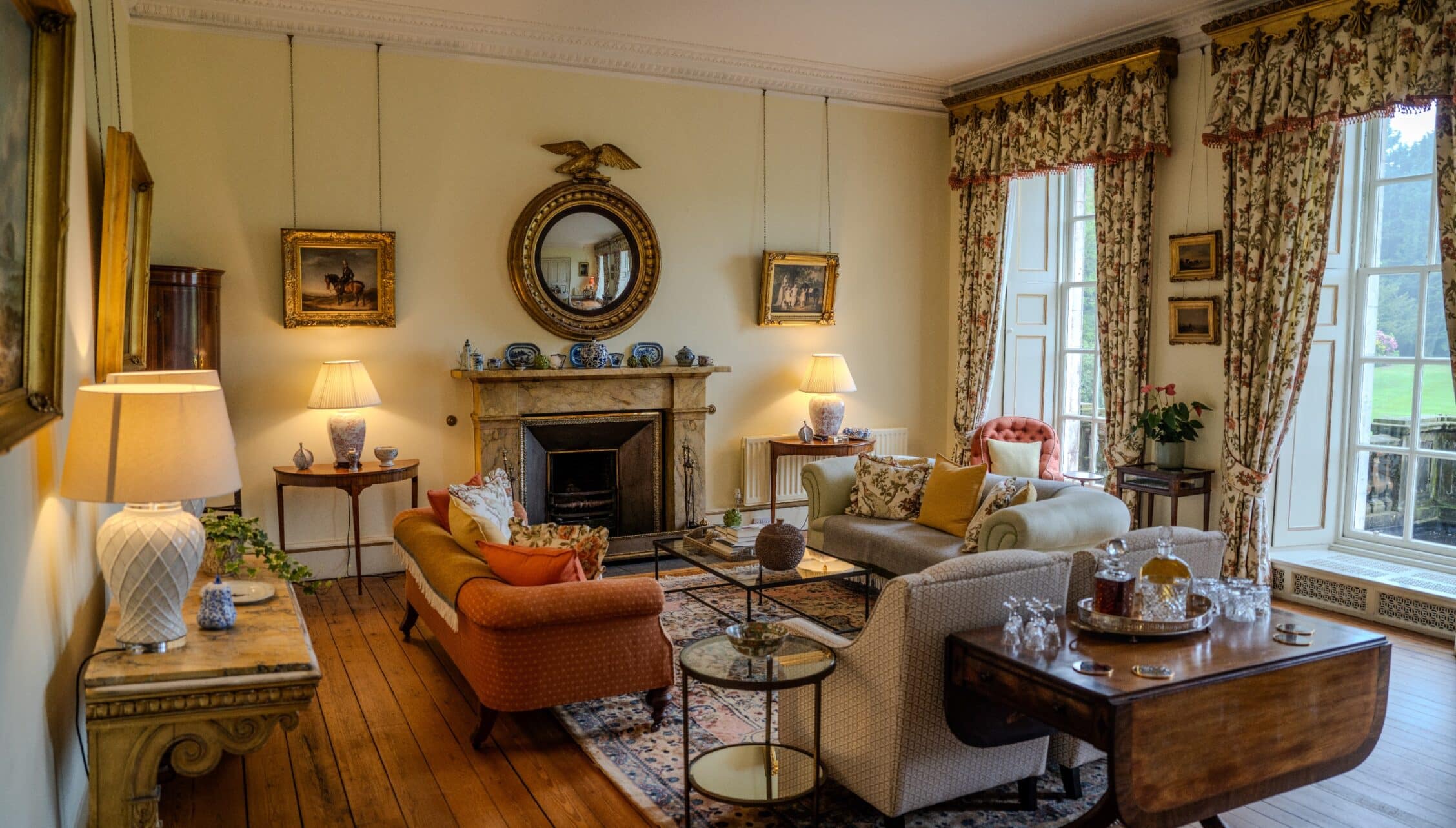 Gilmerton House, East Lothian – Formal drawing room with marble fireplace, gilded mirrors, and patterned curtains.