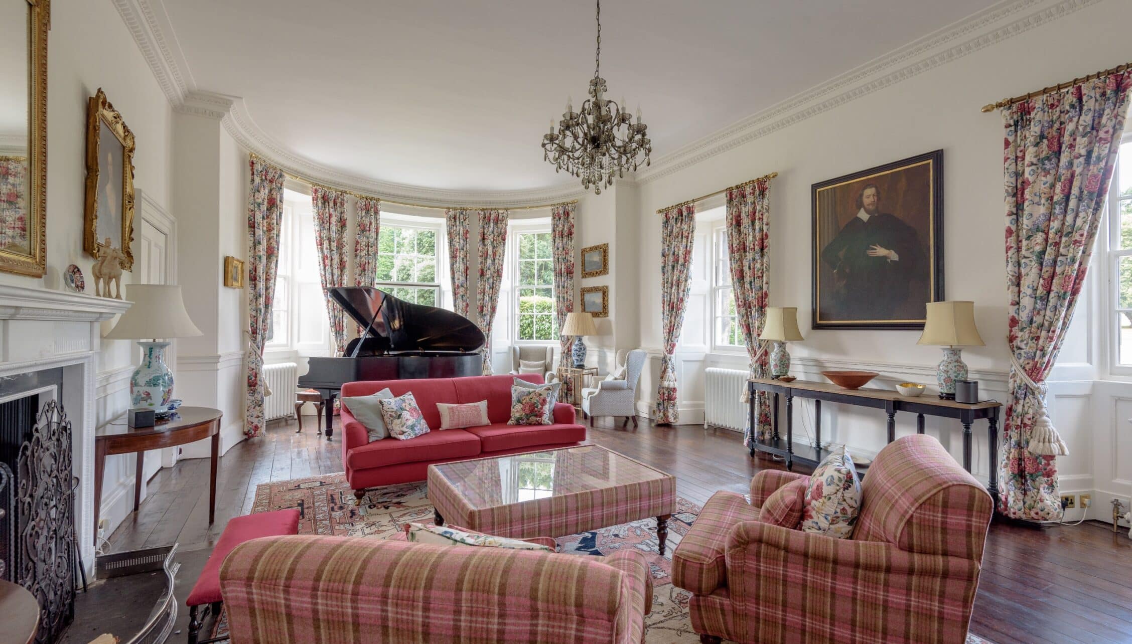 Gilmerton House, East Lothian – Grand drawing room with grand piano, red sofa and floral curtains.