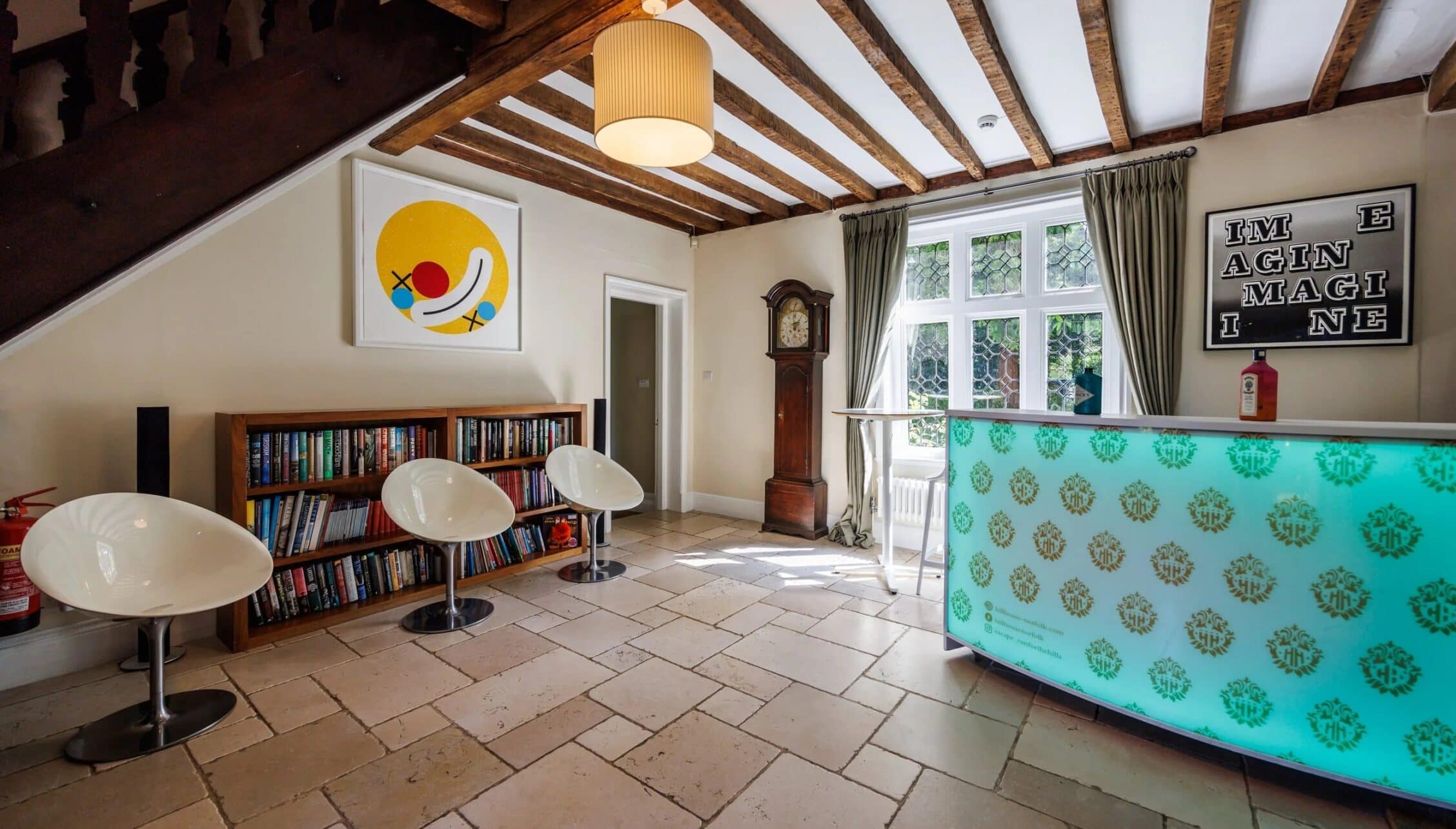 Hill House Norfolk, Norfolk – Contemporary art studio with exposed timber beams, turquoise patterned partition and white sculptural furniture.