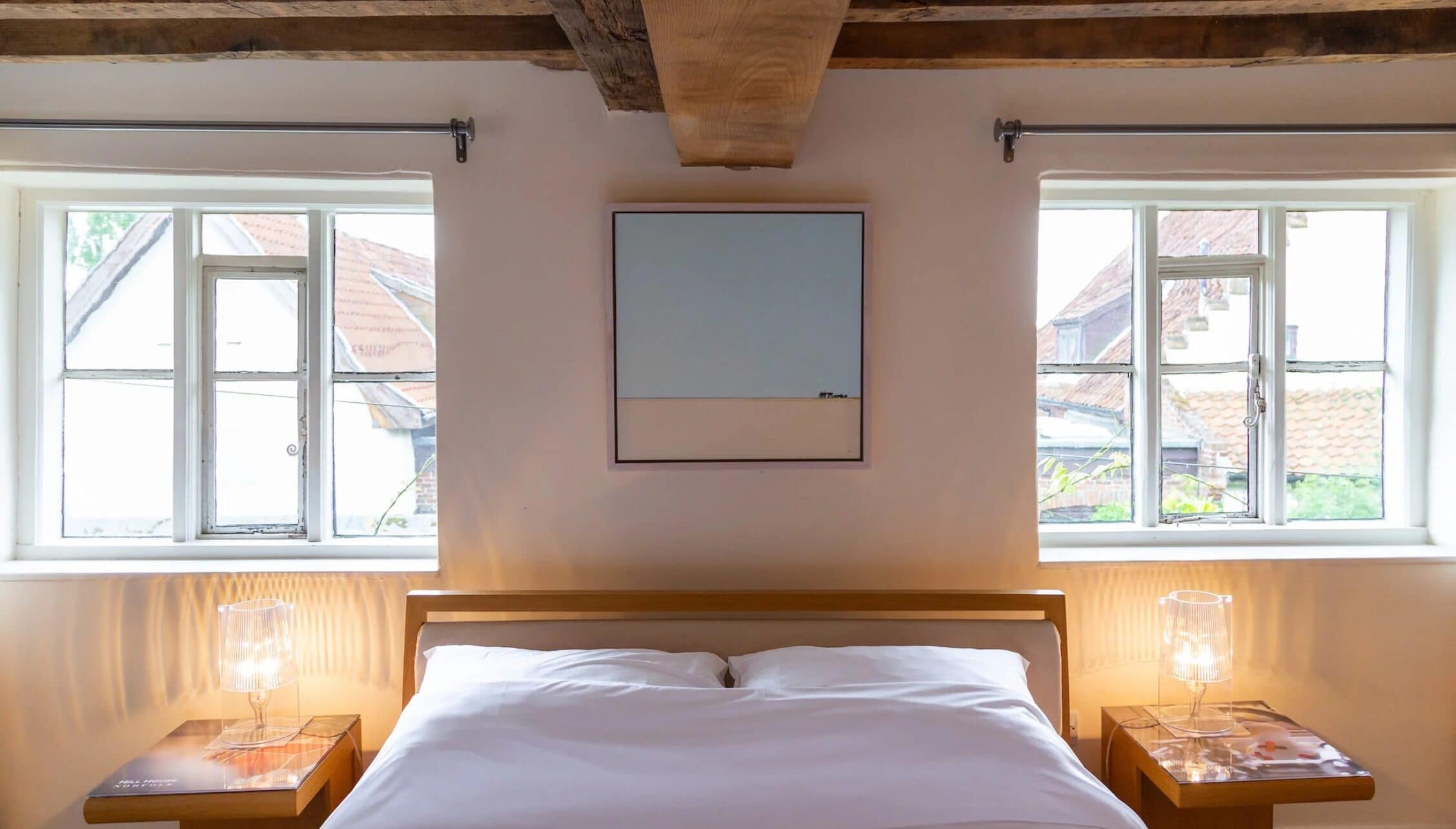 Hill House Norfolk, Norfolk – Contemporary bedroom with exposed wooden beams, white bedding, and countryside views.