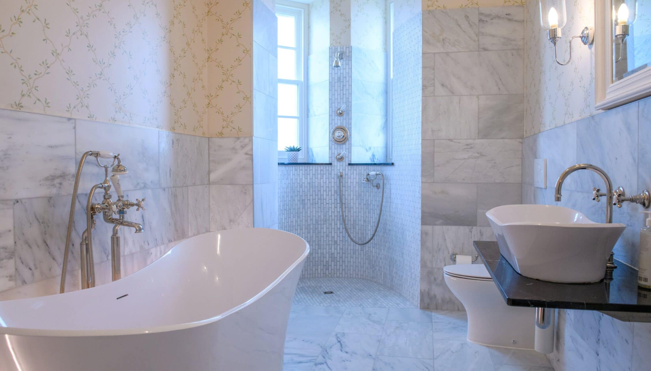 House of the Northern Gate, Highland – Luxury bathroom with freestanding bath, walk-in shower and marble tiling.
