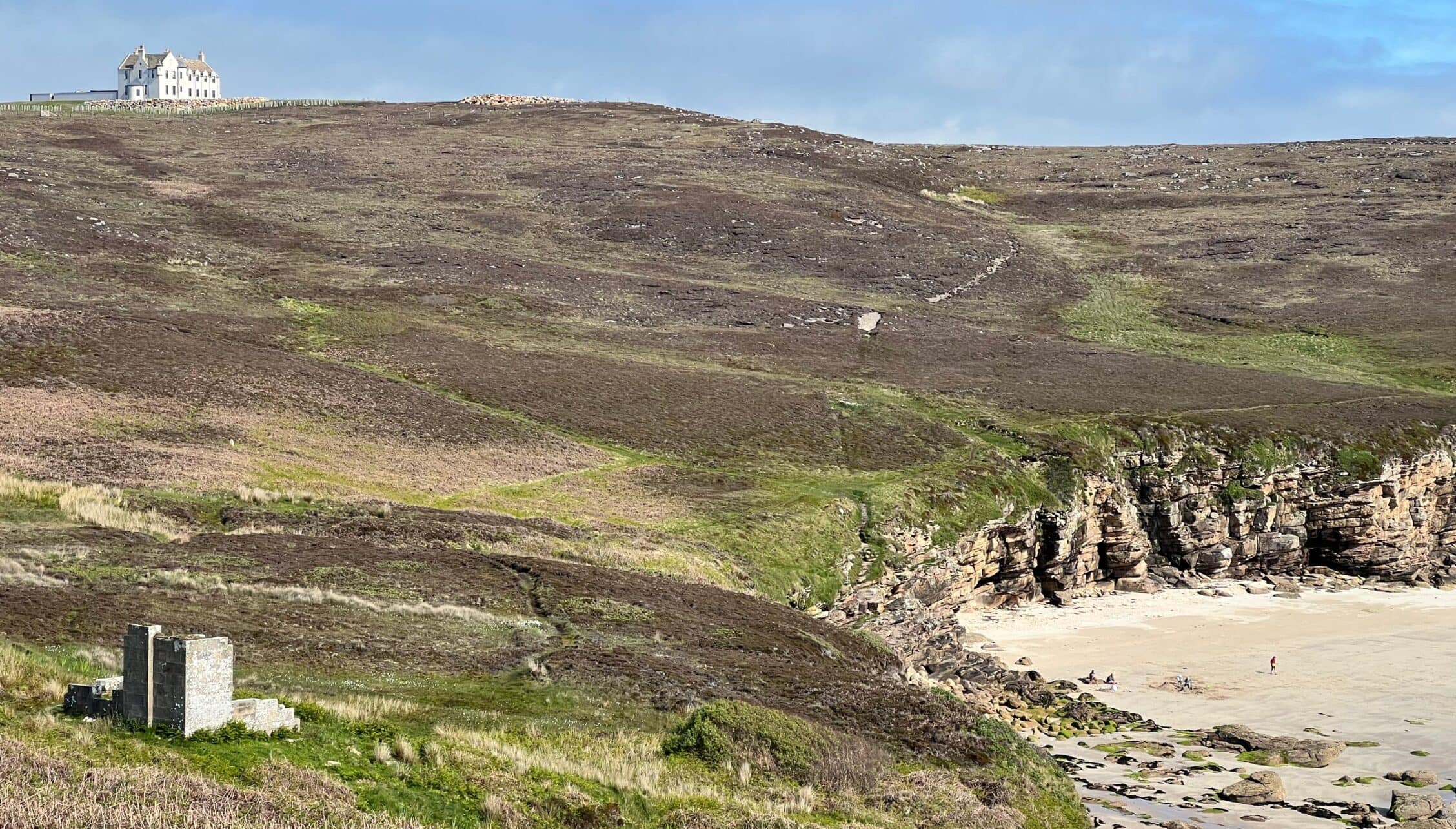 House of the Northern Gate, Highland – Victorian mansion on moorland hilltop overlooking rocky beach cove.