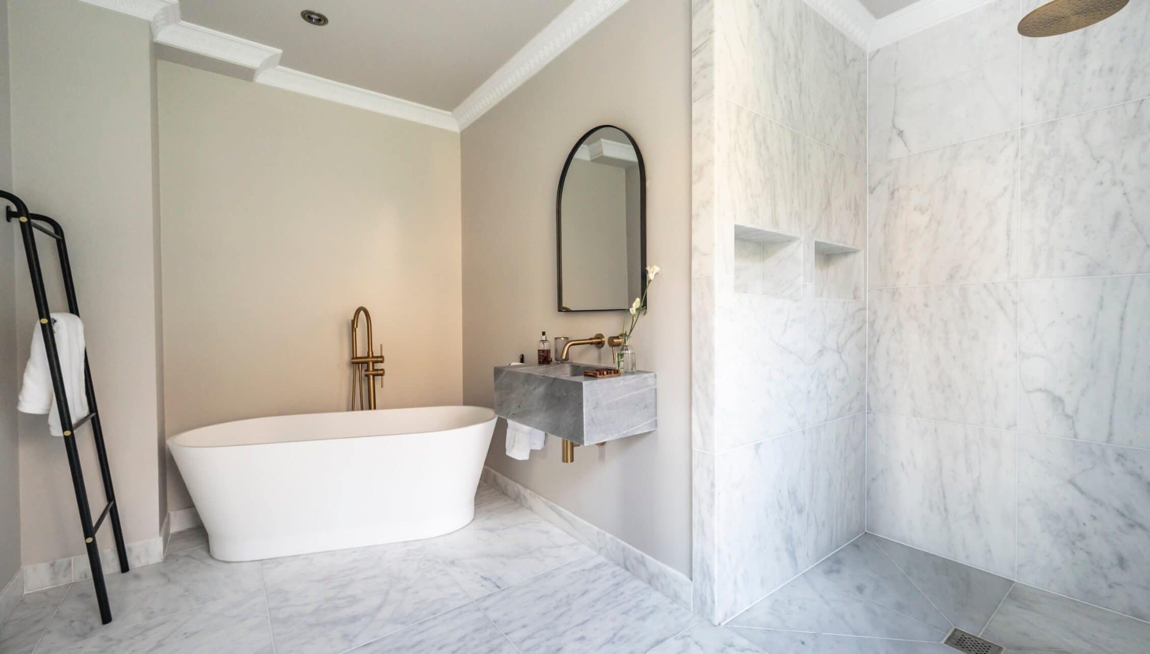 Manar House, Aberdeenshire – Contemporary bathroom with freestanding white bath and marble-tiled walk-in shower.