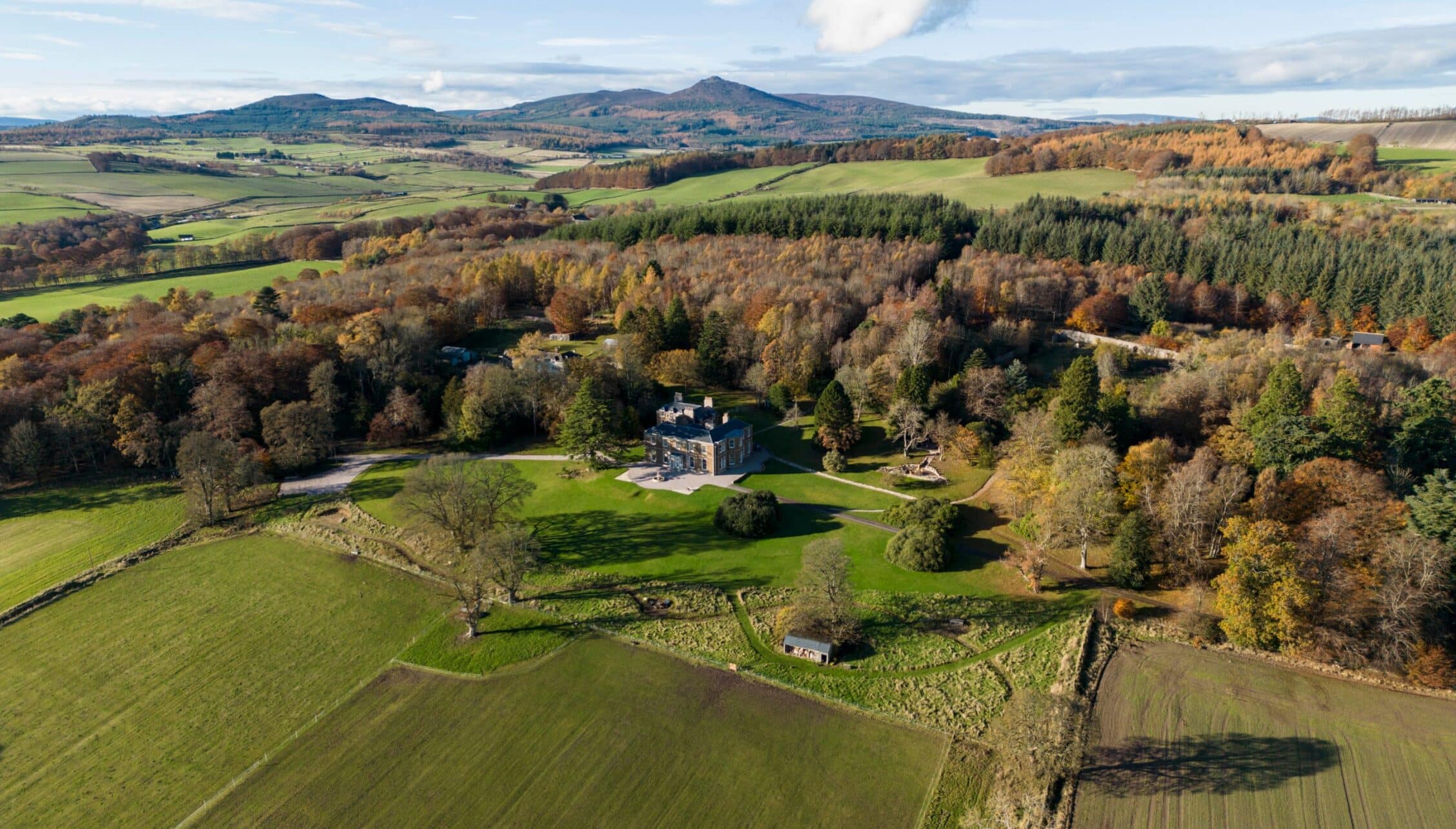 Manar House, Aberdeenshire – Stone mansion surrounded by woodland and parkland, with mountains visible in distant landscape.