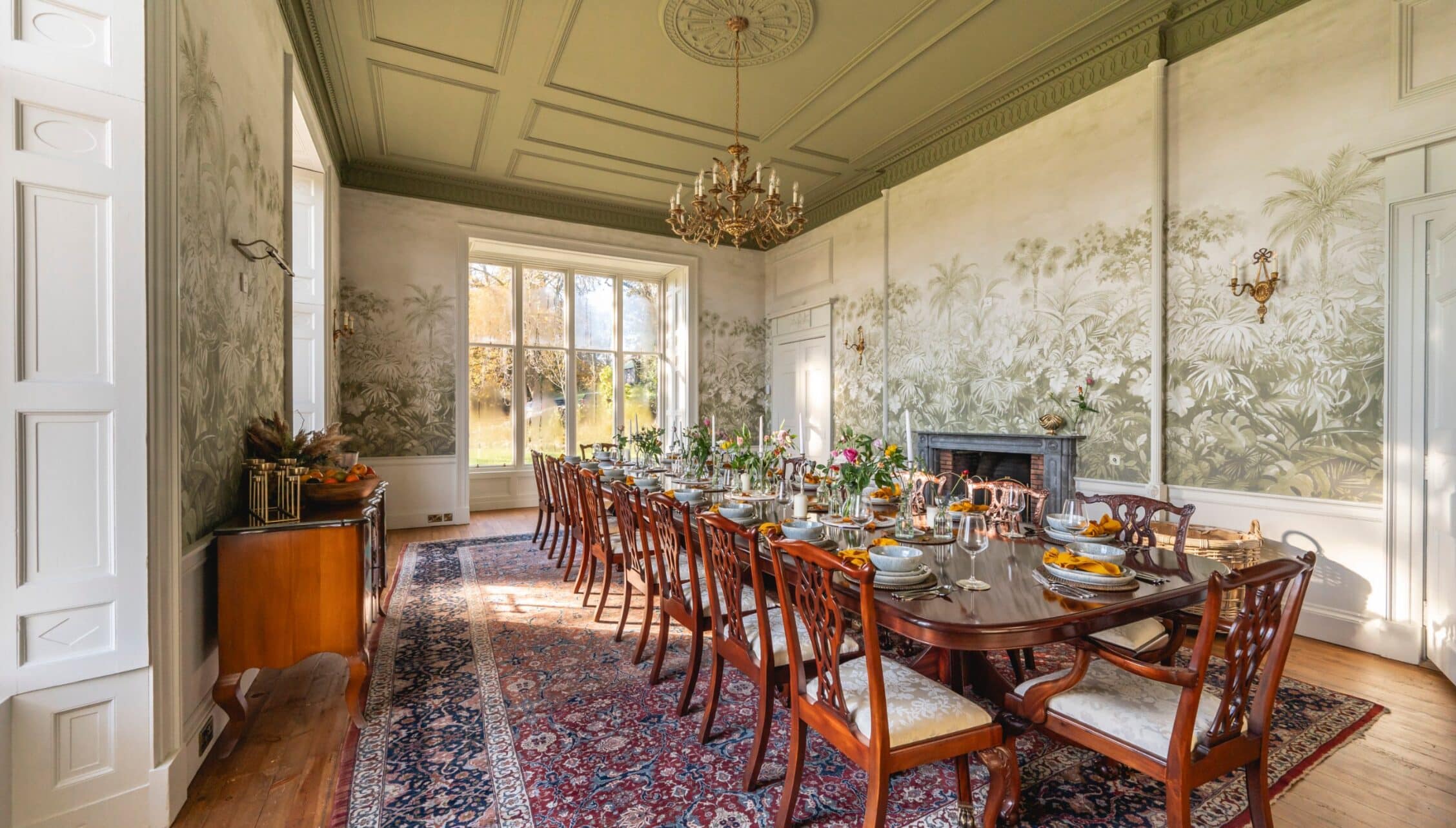 Manar House, Aberdeenshire – Formal dining room with botanical wallpaper, chandelier, and mahogany table.