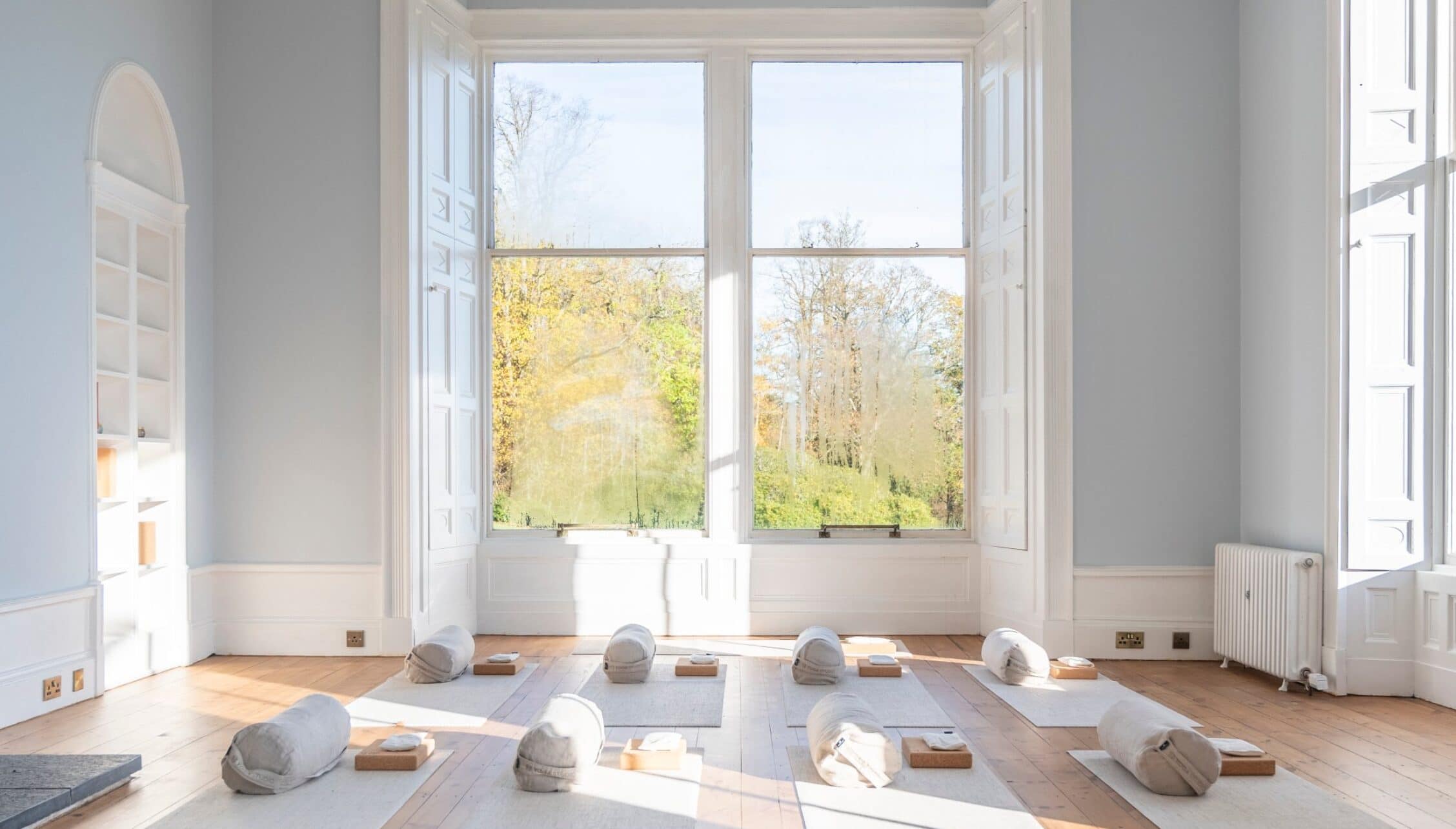 Manar House, Aberdeenshire – Yoga studio with wooden flooring, large sash windows and countryside views.
