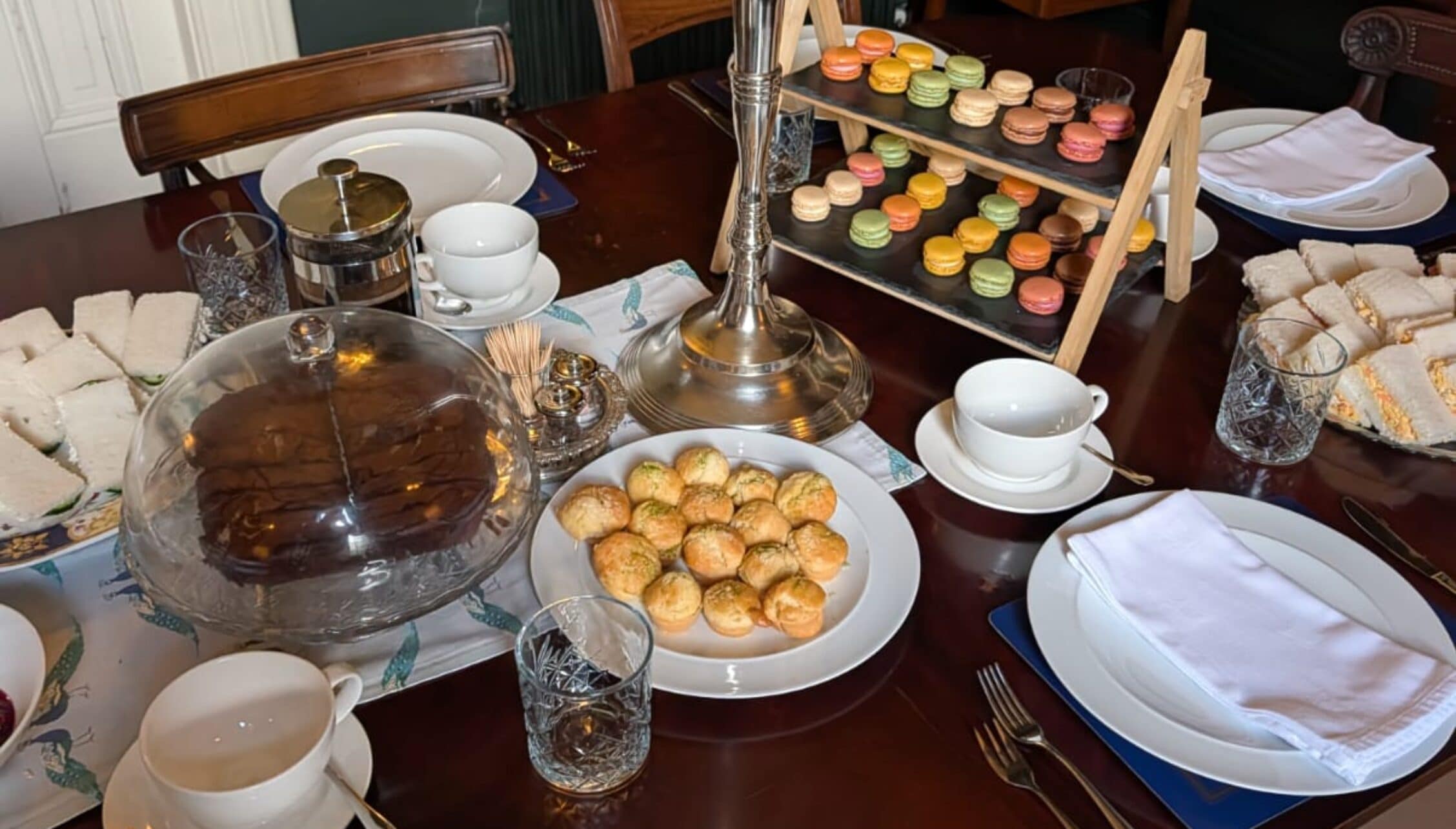 Wardhill Castle, Aberdeenshire – Formal dining table laid with cakes, macarons and afternoon tea service.