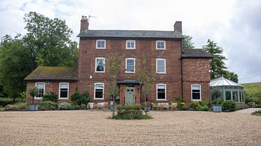 The Manners Arms, Lincolnshire – Red brick Georgian country house with gravel forecourt and glazed conservatory extension.