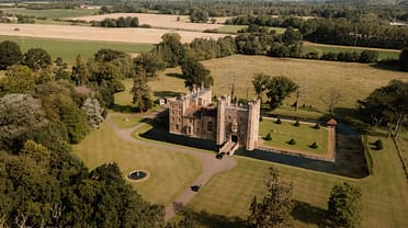 Middleton Castle – Aerial view of castle with moat, formal grounds and surrounding parkland with woodland.