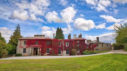 Colehayes Park – Red-ivy-clad country house with stone façade and manicured lawns.