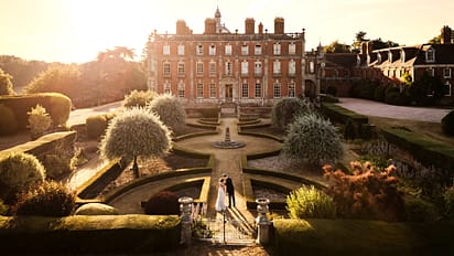 Berwick House, Shropshire – Red-brick country house with formal parterre garden and topiary at sunset.