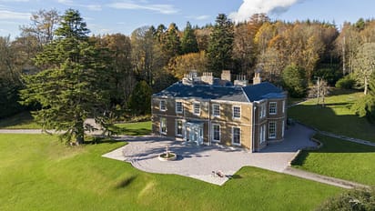 Manar House, Aberdeenshire – Georgian stone mansion with blue roof and chimney stacks, surrounded by autumn woodland and manicured lawns.