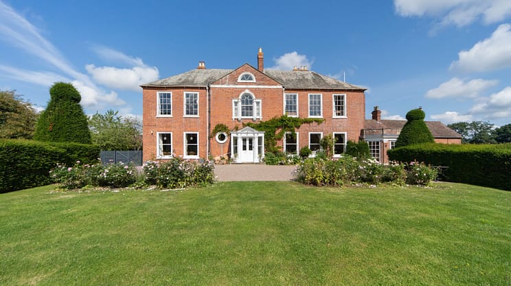 Barton Court, Herefordshire – Red-brick Georgian mansion with manicured lawns and topiary hedges.