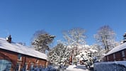 Breedon Hall, Leicestershire – Red brick converted farm buildings with snow-covered grounds and frost-laden trees.